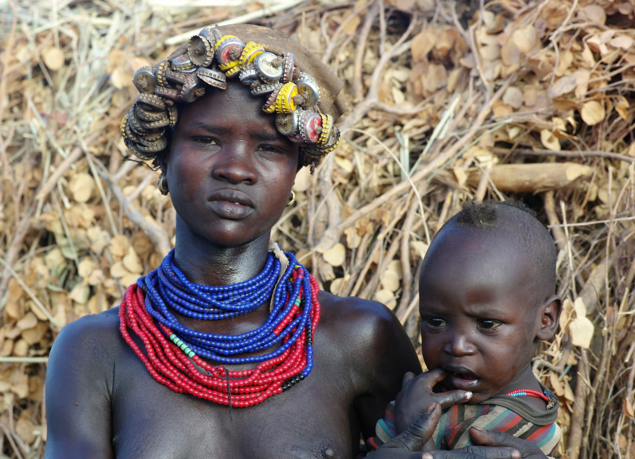 women tribe with bottle caps as a hat